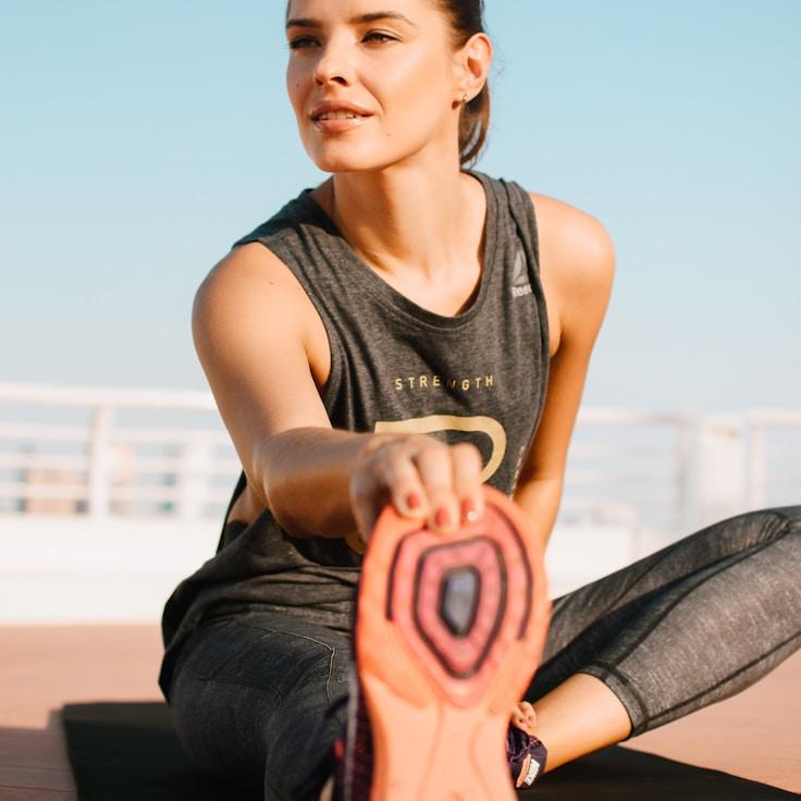 Women in a fitness class doing stretching and mobility exercises